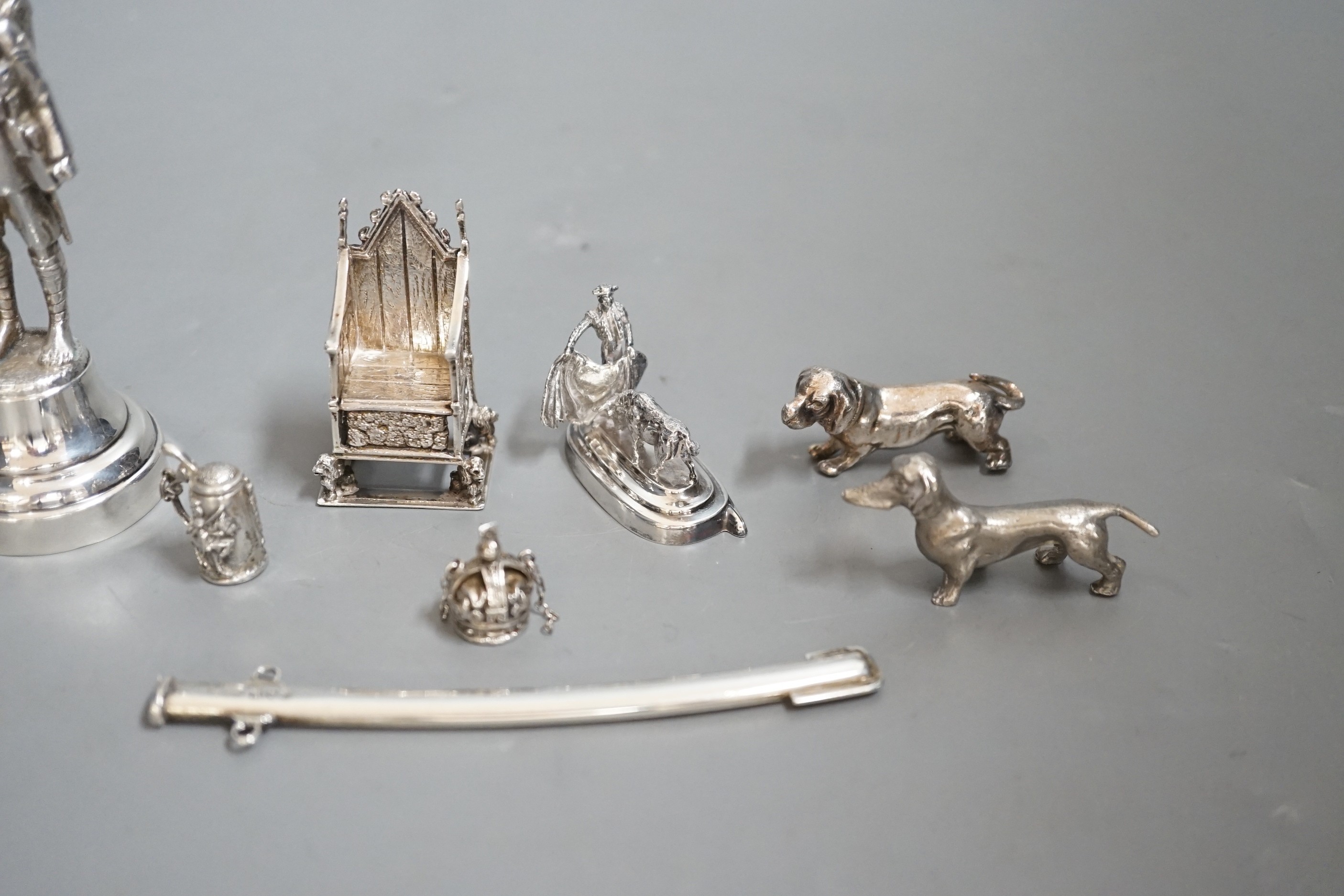 A group of novelty miniature silver items to include a sword, a solider by Goldsmiths & Silversmiths Co Ltd, London, 1930, 10.5cm, a throne, a matador figure, etc.